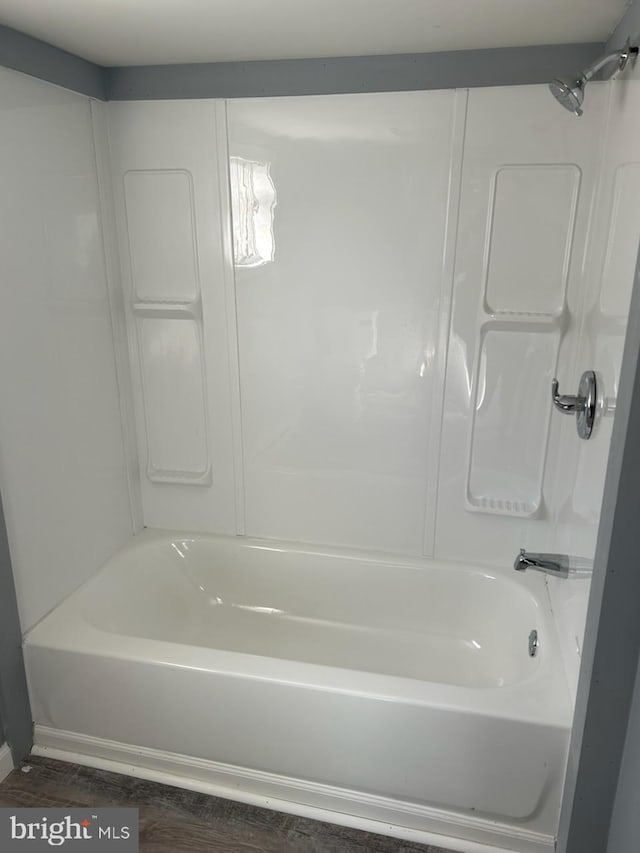 bathroom with bathing tub / shower combination