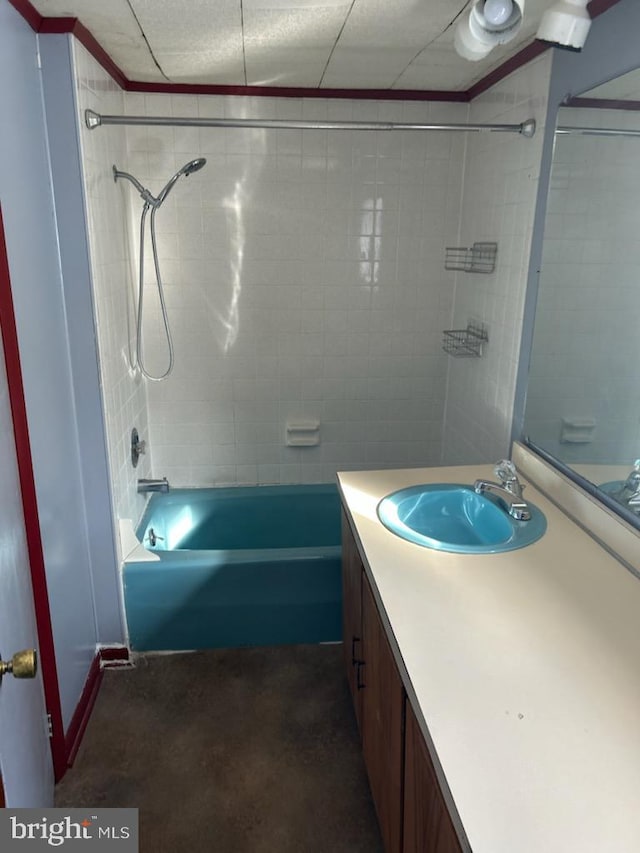 bathroom with vanity and tiled shower / bath