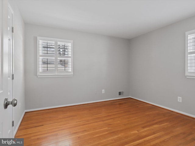 empty room with light hardwood / wood-style flooring