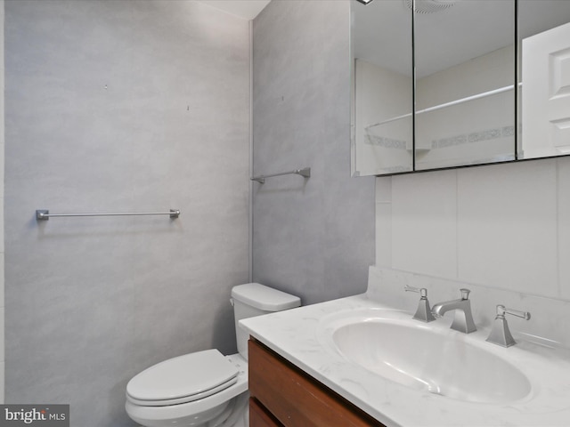 bathroom featuring vanity and toilet