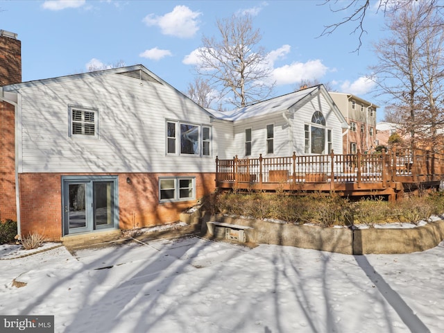 rear view of house featuring a wooden deck