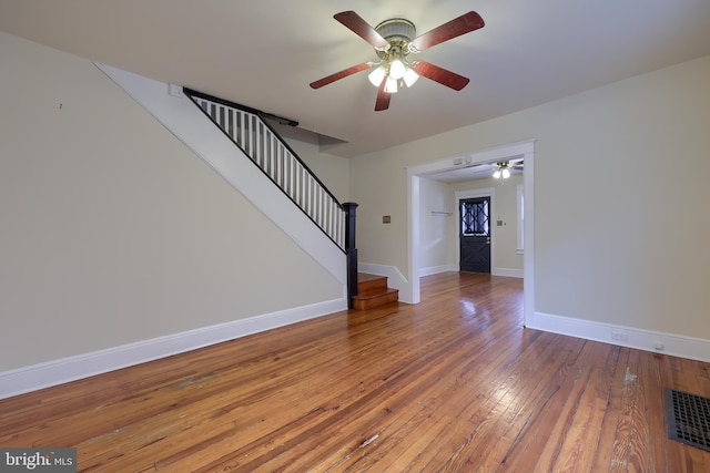 unfurnished living room featuring wood-type flooring and ceiling fan