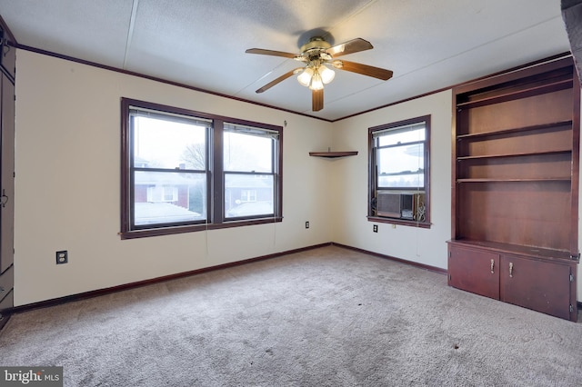 unfurnished bedroom with multiple windows, a textured ceiling, light colored carpet, and ceiling fan