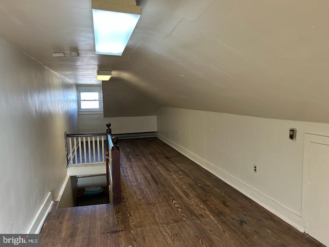 additional living space with dark hardwood / wood-style floors and vaulted ceiling