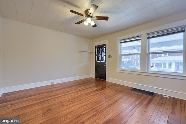 empty room with hardwood / wood-style flooring and ceiling fan