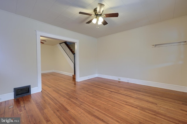 empty room with hardwood / wood-style flooring and ceiling fan