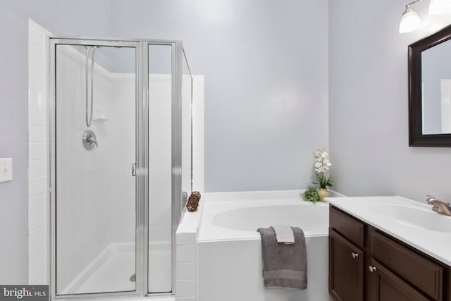 bathroom with shower with separate bathtub and vanity