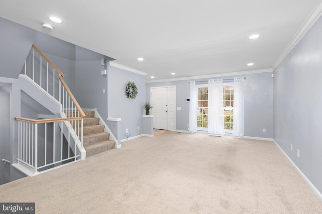 unfurnished living room featuring ornamental molding and carpet floors