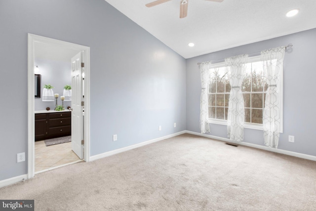 carpeted empty room with lofted ceiling and ceiling fan