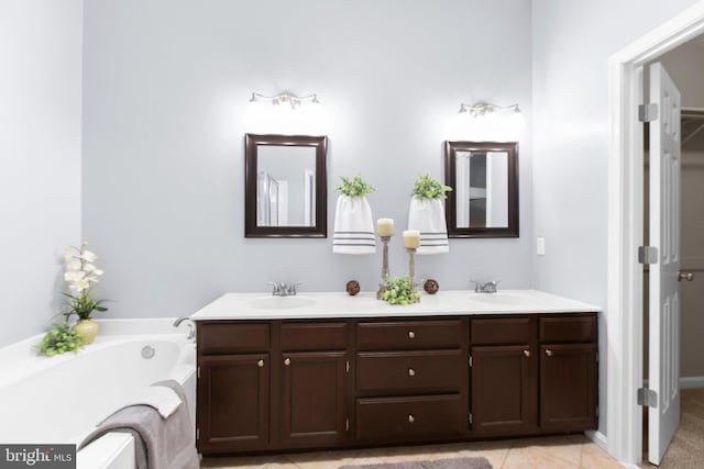 bathroom with tile patterned flooring, vanity, and a bathtub