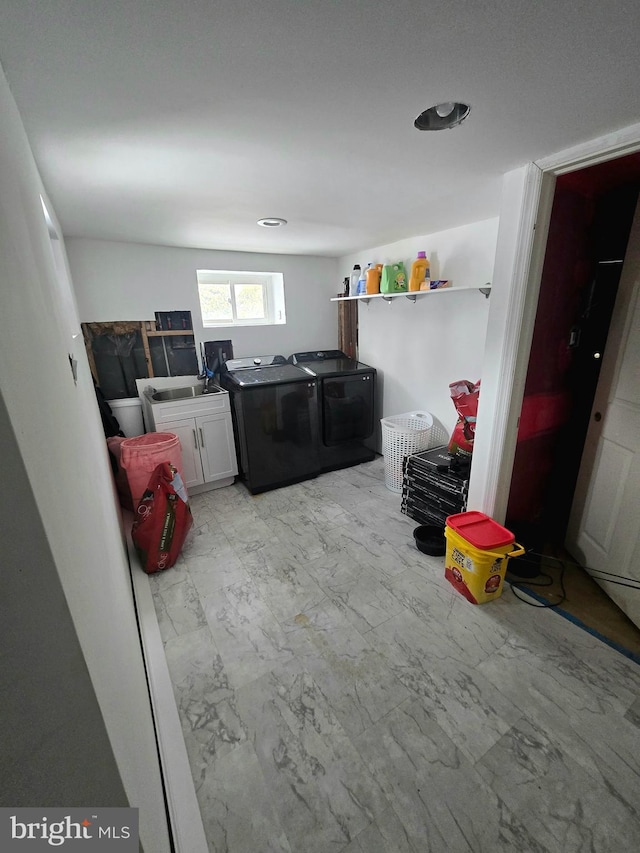 washroom with washer and clothes dryer and cabinets