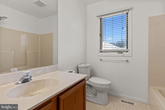 bathroom featuring toilet, vanity, and tile patterned floors