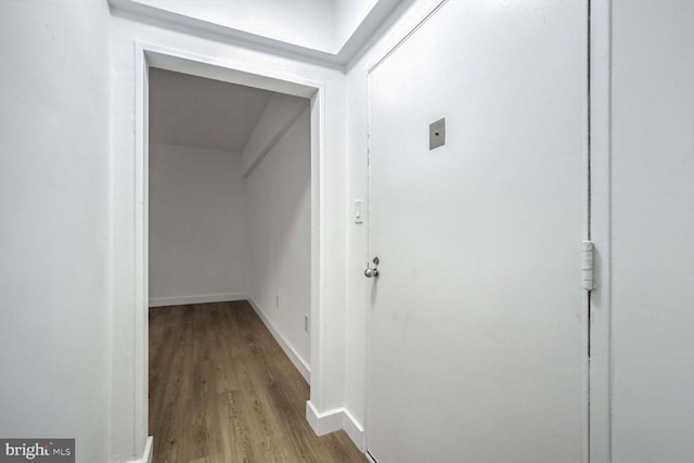 corridor with hardwood / wood-style floors