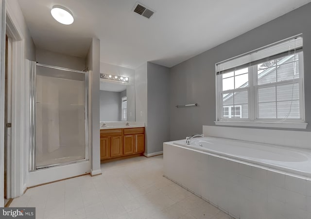 bathroom with separate shower and tub and vanity