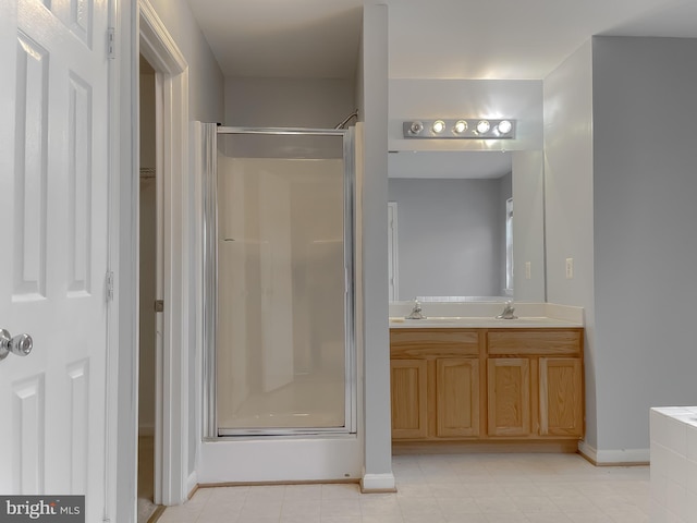 bathroom with walk in shower and vanity