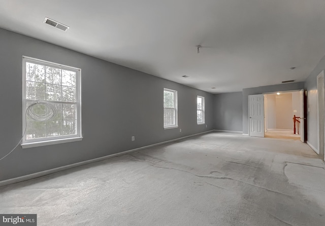 carpeted spare room with plenty of natural light