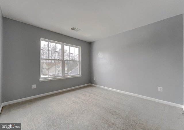 empty room featuring light colored carpet