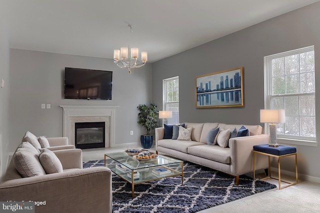 living room with a notable chandelier and carpet flooring