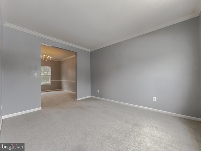 carpeted empty room featuring a chandelier and crown molding