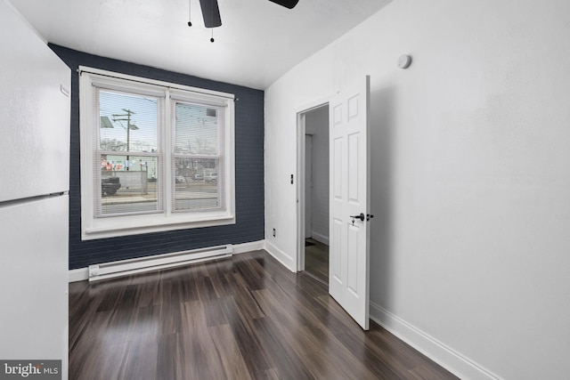 empty room featuring ceiling fan, dark hardwood / wood-style floors, lofted ceiling, and a baseboard radiator