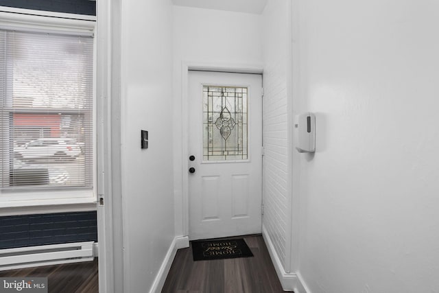 doorway with hardwood / wood-style floors and a baseboard radiator