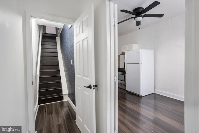 stairway with hardwood / wood-style flooring and ceiling fan