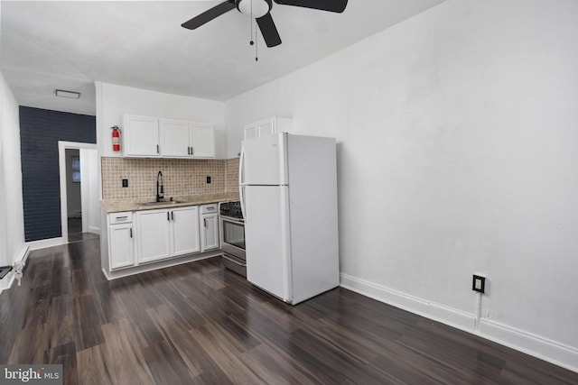 kitchen with white cabinets, white refrigerator, stainless steel range with gas cooktop, and sink