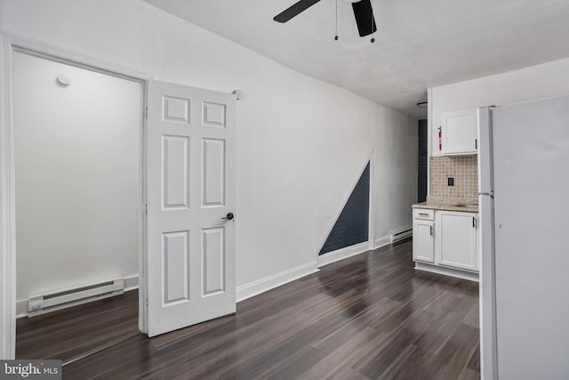 unfurnished living room with ceiling fan, dark hardwood / wood-style flooring, and a baseboard radiator