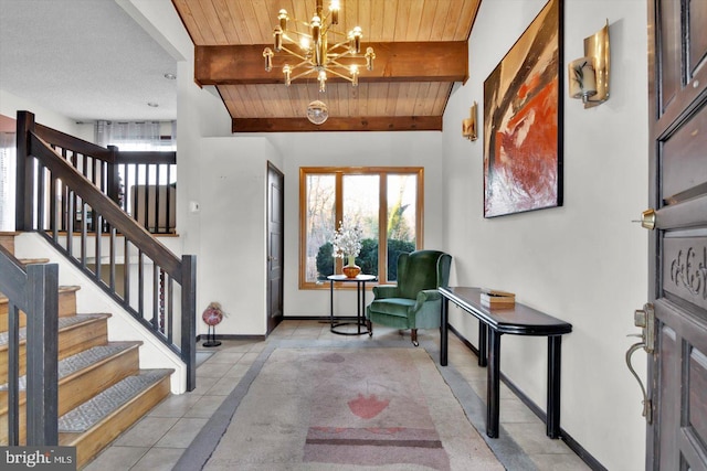 tiled foyer featuring beam ceiling, an inviting chandelier, and wooden ceiling