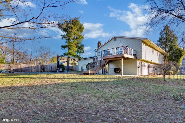 back of property with a lawn and a wooden deck