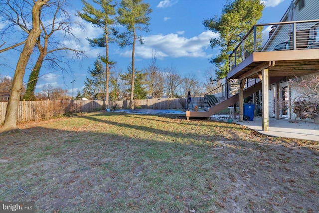 view of yard featuring a patio area and a wooden deck