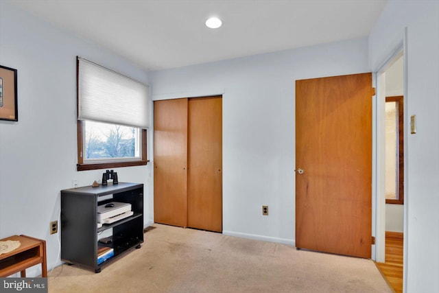 bedroom with a closet and light colored carpet