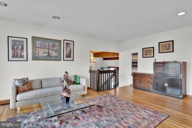 living room featuring a textured ceiling and light hardwood / wood-style flooring