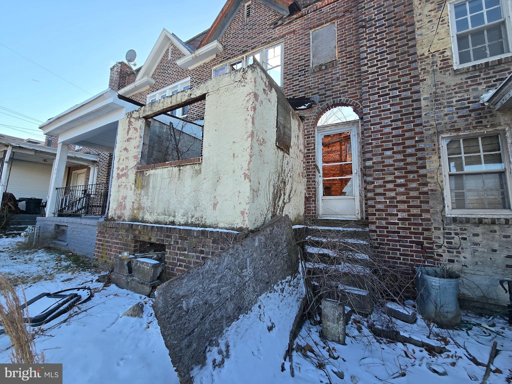 view of snow covered property entrance