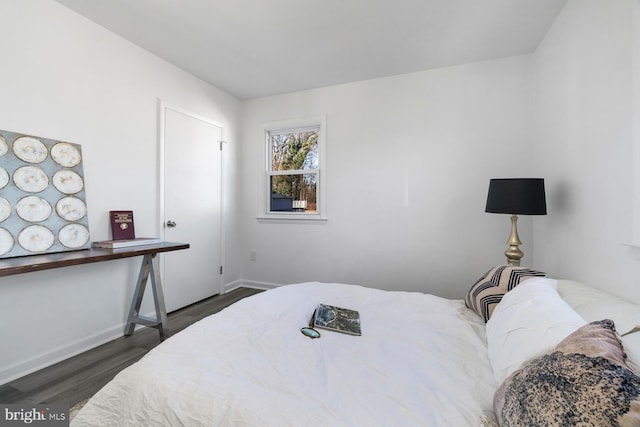 bedroom with dark hardwood / wood-style flooring