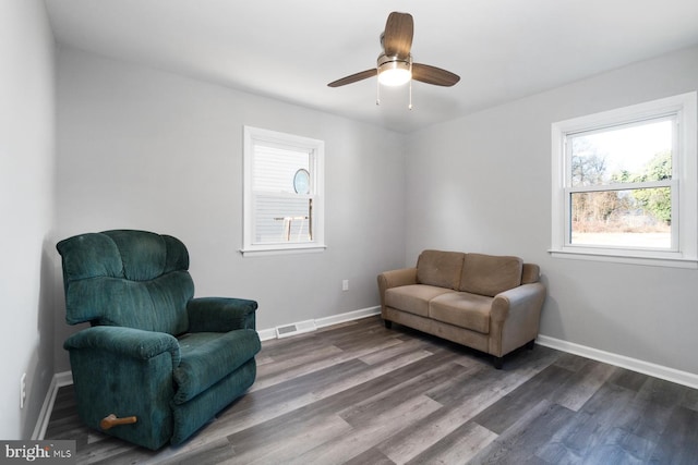 living area featuring hardwood / wood-style flooring, ceiling fan, and plenty of natural light