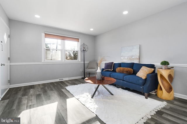 living room with dark hardwood / wood-style flooring