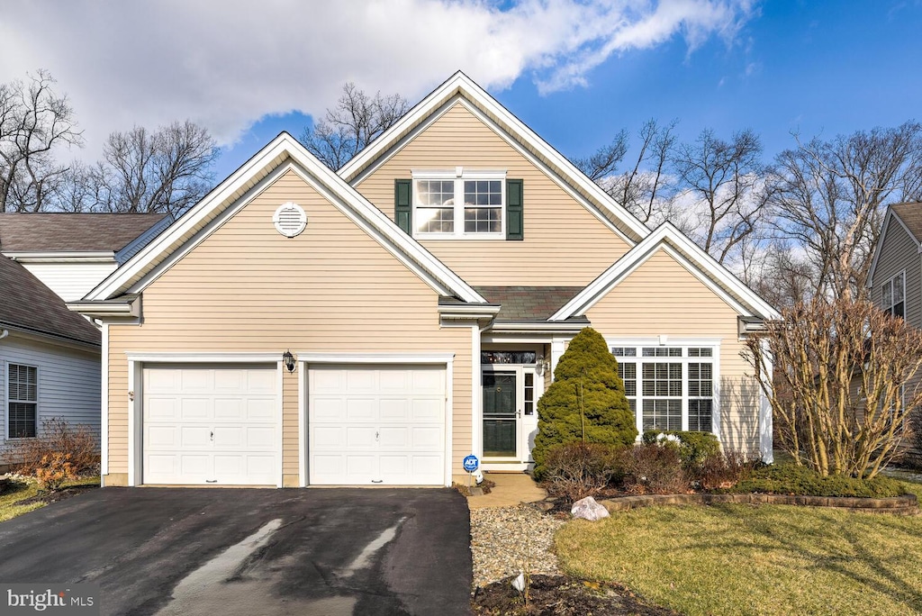 front facade featuring a front yard and a garage