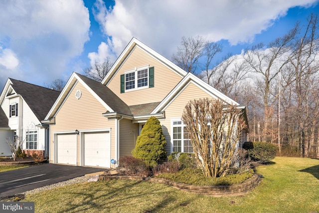 view of front property featuring a front yard and a garage