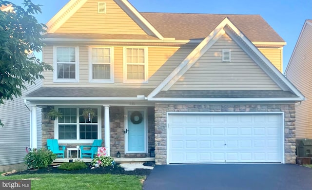 view of front of home featuring covered porch and a garage