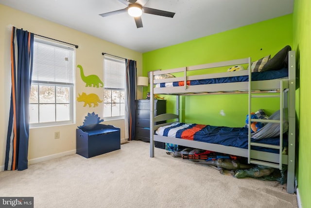 bedroom with ceiling fan and light carpet