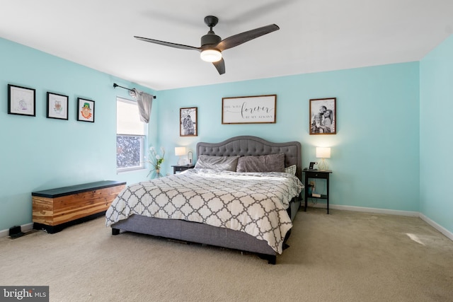 bedroom with ceiling fan and light carpet