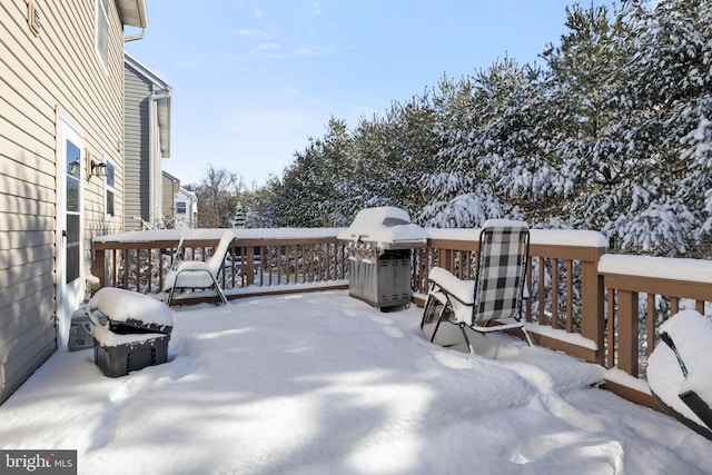 snow covered deck featuring area for grilling