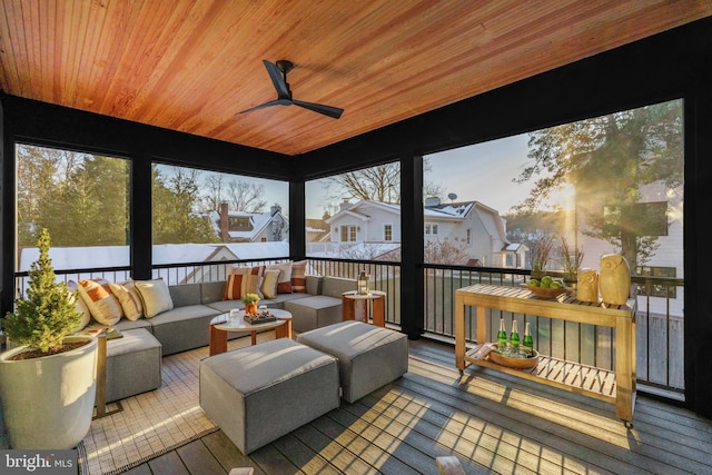 sunroom with ceiling fan and wood ceiling