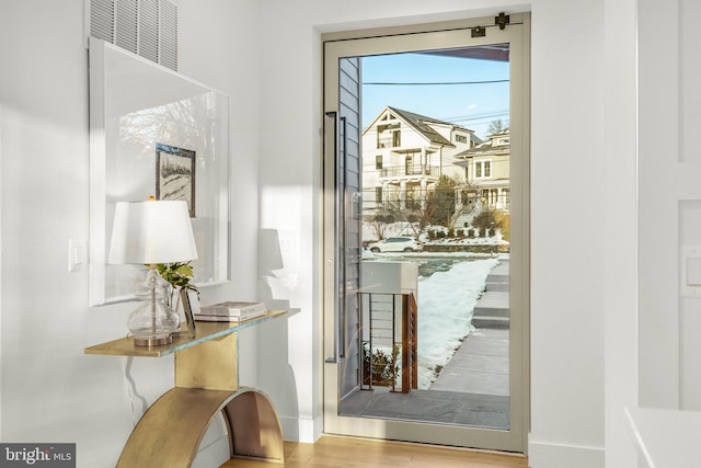 doorway to outside featuring wood-type flooring