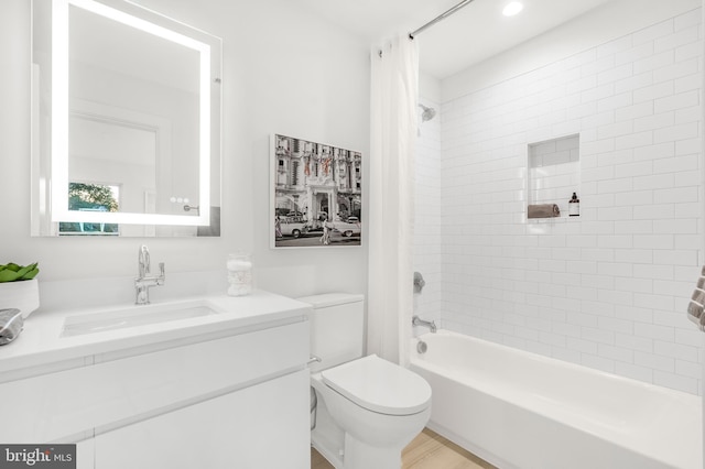 full bathroom featuring toilet, shower / bathtub combination with curtain, and vanity