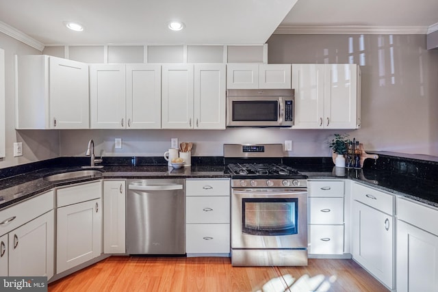 kitchen with sink, white cabinets, and appliances with stainless steel finishes