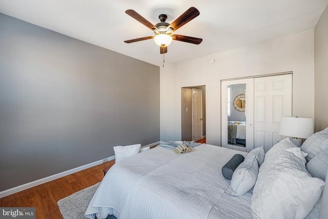 bedroom featuring hardwood / wood-style floors, a closet, and ceiling fan