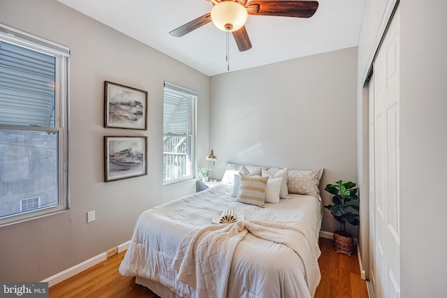 bedroom with light hardwood / wood-style floors, a closet, and ceiling fan