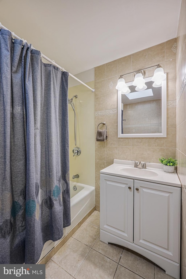 bathroom featuring tile walls, vanity, shower / bath combination with curtain, tile patterned flooring, and decorative backsplash